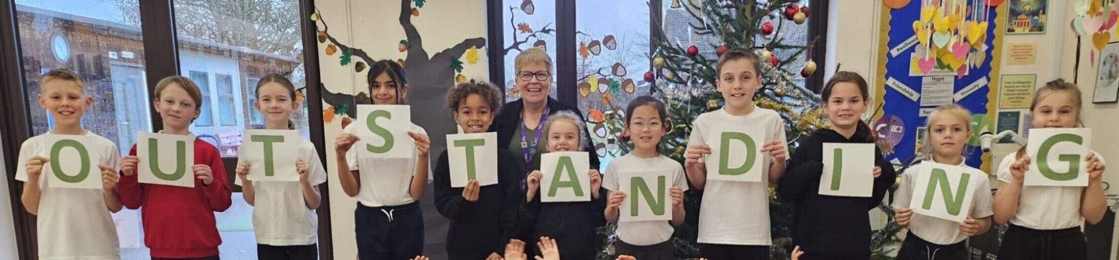 Pupils from Dickleburgh Primary Academy celebrating with their Executive Headteacher, Mrs Moira Croskell